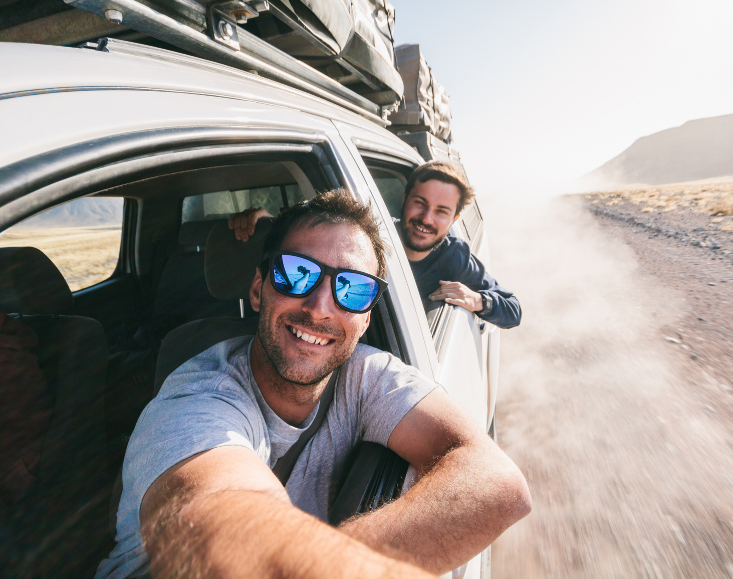 Adventure travel - Two young men taking a self portrait through